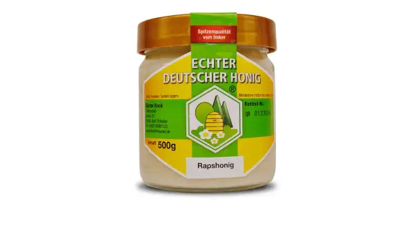 Glas mit cremigem Rapshonig, "Echter Deutscher Honig" steht drauf. Dieser Honig ist gesund und lecker.